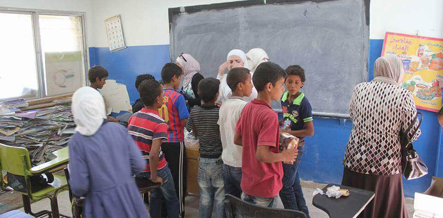 Activists from Jordanian universities distribute winter clothes to schoolchildren in Tafileh recently (Photo courtesy of Hadeel Muhaisen)
